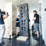 The M Network's film crew tapes the Artex Fine Art Services team uncrating "Dream House XLIII". Photography by Sid Hoeltzell.